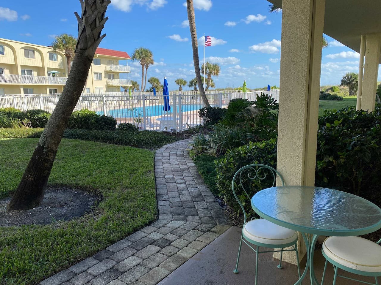 Patio leading to community pool near the beach